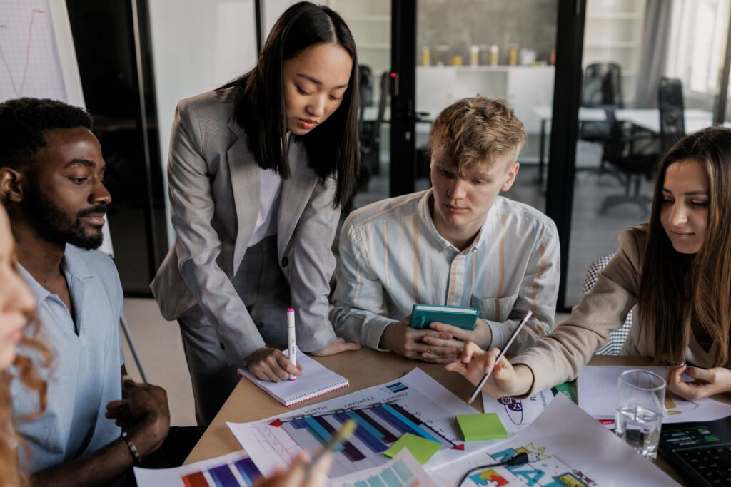 Young professionals collaborating during a direct marketing campaign while building confidence through customer interactions